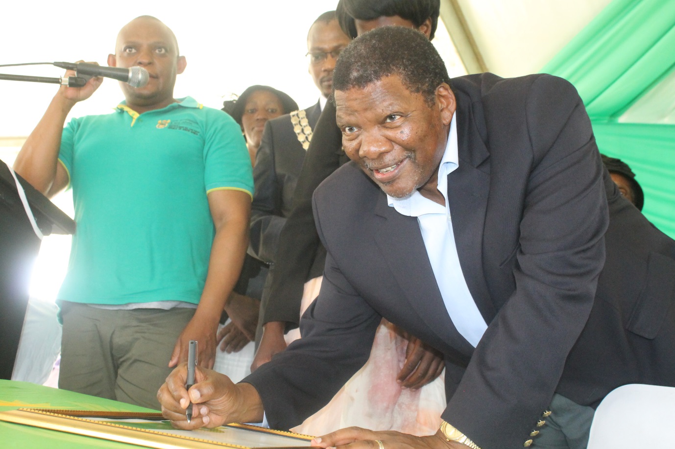 Minister Gugile signing a Land Use Rights certificates